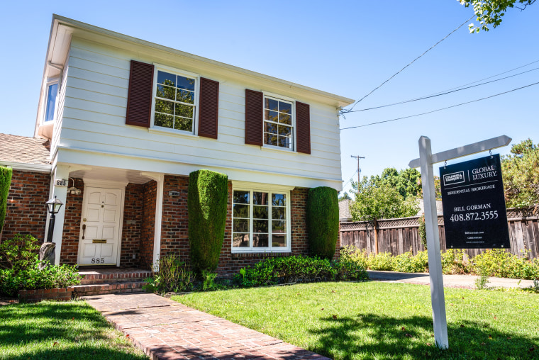 Image: A home advertised for sale in a residential neighborhood 